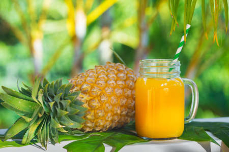 Fresh yellow pineapple tropic fruit summer refreshment smoothie shake drink outdoorsの写真素材