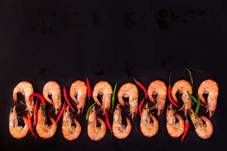 Perfect cooked prawns shrimps with herbs, spices and text space note book top view flat lay LAYOUTの写真素材