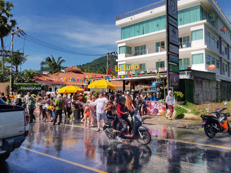 Phuket, Thailand - April 13, 2018: Crowd of People participate in water battle fights with guns and ladles celebrate traditional Thai New Year - Songkran Festival, photo was taken on mobile phone Samsung Note 8のeditorial素材