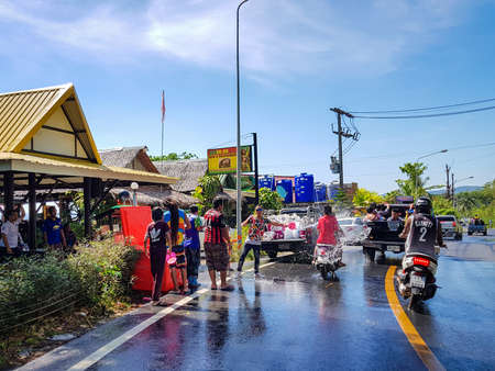 Phuket, Thailand - April 13, 2018: Man pour water on motorbike driver celebrate traditional Thai New Year - Songkran Festival, photo was taken on mobile phone Samsung Note 8のeditorial素材
