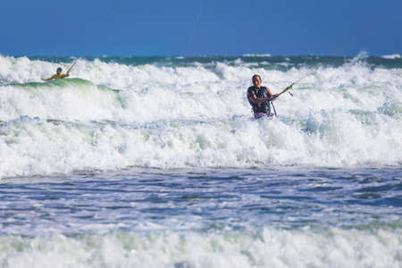 Young athletic man riding kite surf on a sea in Vietnamの写真素材