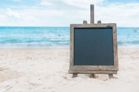 Chalk board with sunscreen cream in the sand on the beach tropic exotic backgroundの写真素材