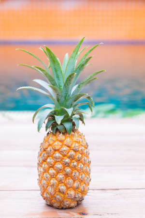 Fresh yellow pineapple tropic fruit summer refreshment smoothie shake drink near poolの写真素材