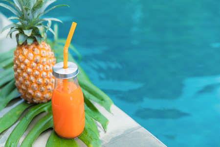 Fresh yellow pineapple tropic fruit summer refreshment smoothie shake drink near pool