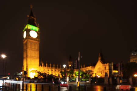 Popular tourist Big Ben and Houses of Parliament in night lights illumination blur unfocused in London, England, United Kingdomの写真素材