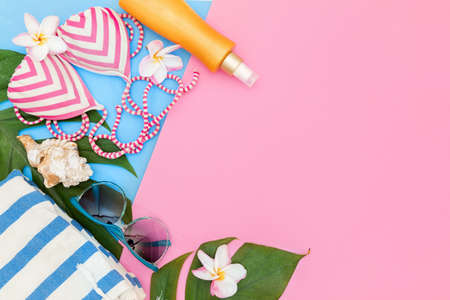 Tropical top view summer holiday concept still life with monstera liana, vine, palm leaves on pink and blue background flat lay layoutの写真素材