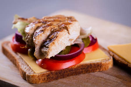 Fresh homemade grilled chicken sandwich on a woodの写真素材
