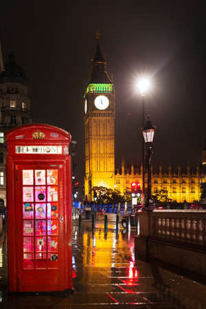 Popular tourist Big Ben and Houses of Parlament with red phone booth in night lights illumination in London, England, United Kingdomの写真素材