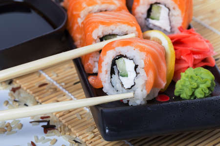 Salmon sushi rolls on a wooden backgroundの写真素材
