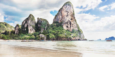 Amzing landscape with traditional longtail boats, rocks, cliffs, beautiful sea tropical and white Railay beach. Popular famous travel vacation  destination Krabi Province, Thailand.の写真素材