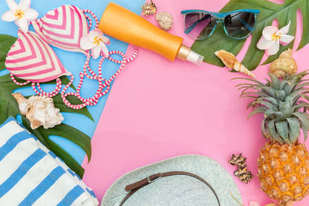 Tropical top view summer holiday concept still life with monstera liana, vine, palm leaves on pink and blue background flat lay layoutの写真素材