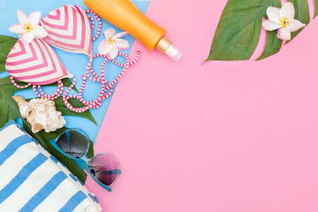 Tropical top view summer holiday concept still life with monstera liana, vine, palm leaves on pink and blue background flat lay layoutの写真素材