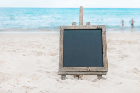 Chalk board with sunscreen cream in the sand on the beach tropic exotic backgroundの写真素材