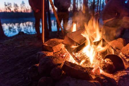 Fireplace in camping near lake at dark nightの写真素材