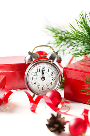 Christmas countdown to the new year. Clock and red balls and fir spruce branches. Holiday composition.の写真素材