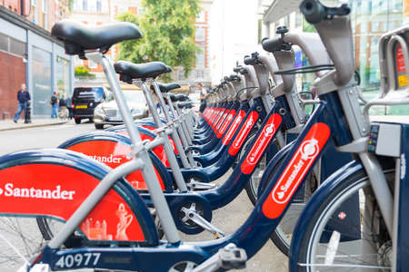 LONDON, ENGLAND, UK - 31 JULY, 2017: Row of Santander red public rental hire bicycles at docking station, known as Boris Bikesのeditorial素材