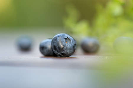 Fresh ripe sweep tasty blueberries outdoors on wooden backgroundの写真素材