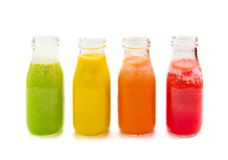 Colourful smoothie juice bottles isolated on white backgroundの写真素材