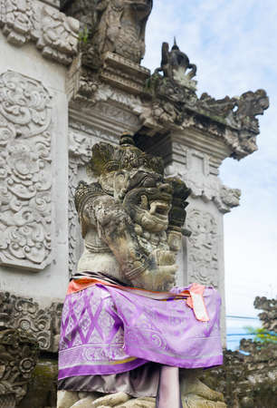 Traditional Balinese statue protecting from evil spirits demon at the entranceの写真素材