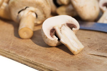 Fresh champignon mushrooms on a wooden deskの写真素材