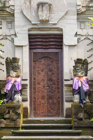 Traditional Balinese statue protecting from evil spirits demon at the entranceの写真素材