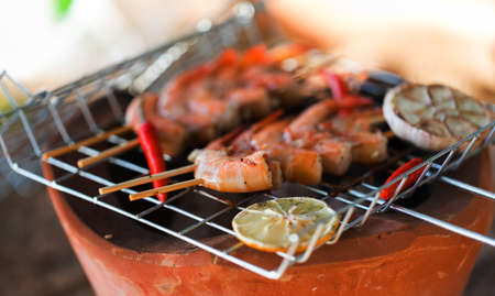 Fresh shrimps on barbecue outdoorsの写真素材