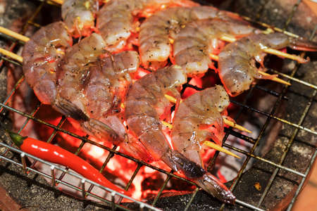 Fresh shrimps on barbecue outdoorsの写真素材