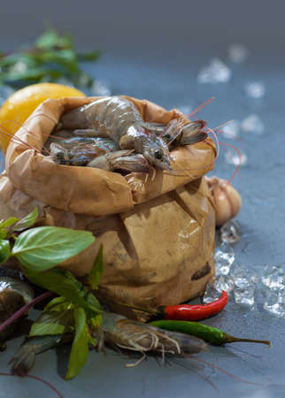 Perfect fresh raw prawns shrimps with herbs, spices and iceの写真素材