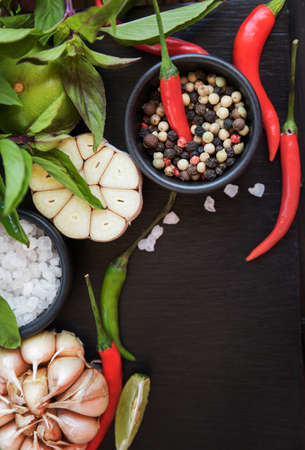 Different types of spices and herbs for cooking on black slate backgroundの写真素材