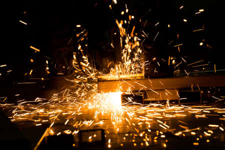 sharpening and cutting of iron by abrasive disk machine industrialの写真素材