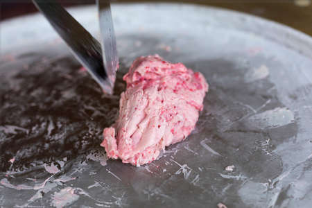 Preparing of pink stir fried ice cream with strawberryの写真素材
