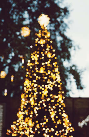 Blur unfocused Christmas tree the bokeh lights effectの写真素材