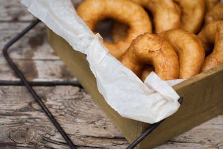 Homemade donuts with icing sugar powder on a woodenの写真素材