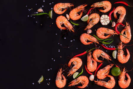 Perfect cooked prawns shrimps with herbs, spices and text space note bookの写真素材