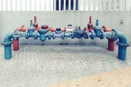 Water pipes joined with valves of the water supply system on a streetの写真素材