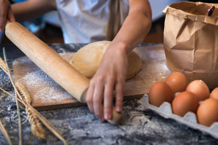 Knead the dough with wheat on a darkの写真素材