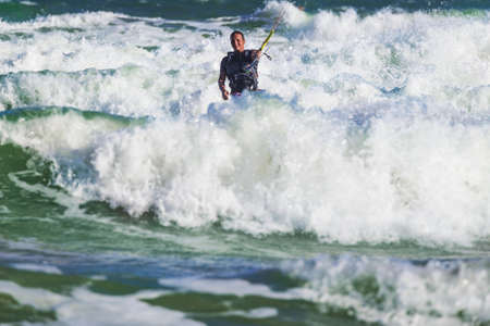 Young athletic man riding kite surf on a sea in Vietnamの写真素材