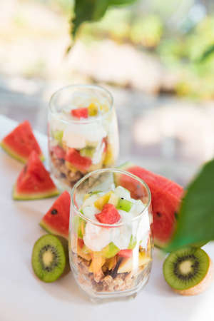 Fresh homemade tropical exotic granola muesli breakfast with fresh fruit cutsの写真素材