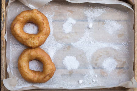 Homemade donuts with icing sugar powder on a woodenの写真素材