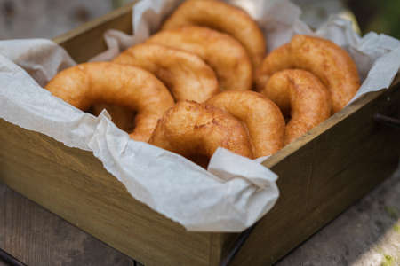 Homemade donuts with icing sugar powder on a woodenの写真素材