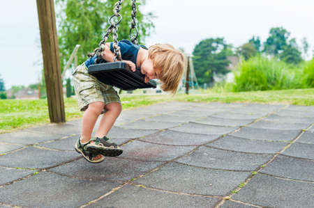 Cute toddler boy playing on playground