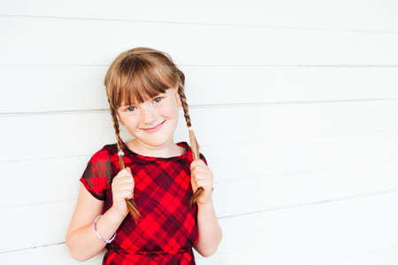 Outdoor portrait of a cute little girl against white backgroundの写真素材