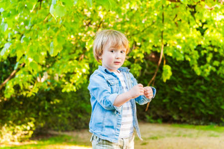 Outdoor portrait of a cute toddler boy on a nice sunny dayの写真素材