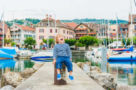 Outdoor portrait of a cute toddler boy in a small beautiful portの写真素材