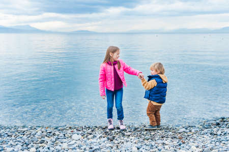 Adorable children playing together outdoorsの写真素材