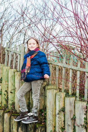 Outdoor portrait of a cute little girl in a park on a nice dayの写真素材
