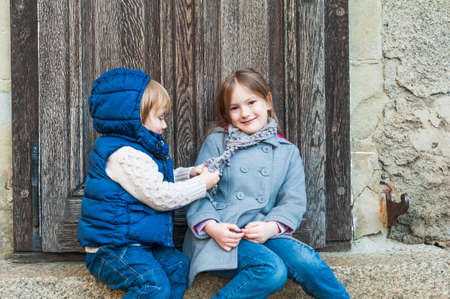 Outdoor portrait of a little girl and her brotherの写真素材