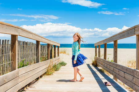 Cute little girl having fun outdoorsの写真素材
