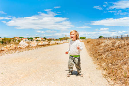 Cute toddler boy having fun outdoorsの写真素材