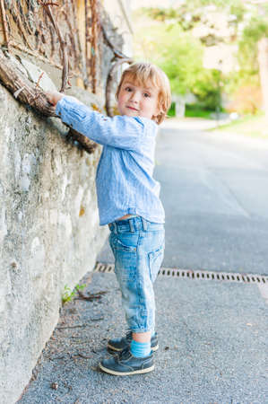 Outdoor portrait of a cute toddler boy on a nice summer dayの写真素材